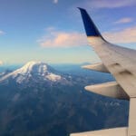 The view from the window seat of an airplane as it flies past Mount Rainier in Washington State